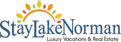The image is a logo for StayLakeNorman, a luxury vacation and real estate company.